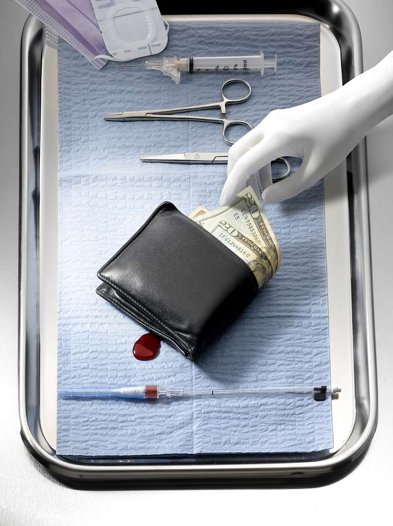 surgeon removing money from wallet