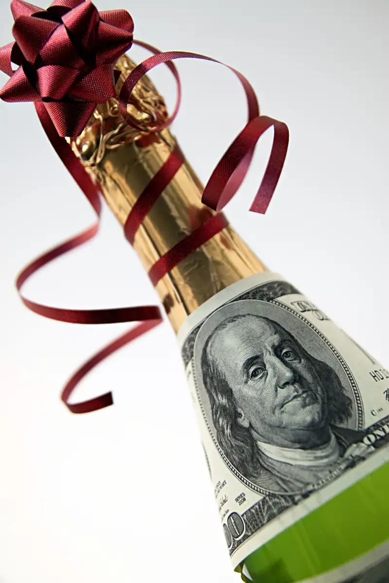 champagne bottle with $100 bill wrapped around it