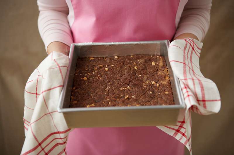 Cashew-caramel brownie in baking pan, elevated view