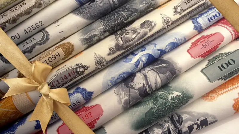 Rolls of stocks with gold bow wrapped around them like a present