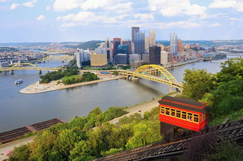 Incline operating in front of the downtown skyline of Pittsburgh, Pennsylvania, USA.