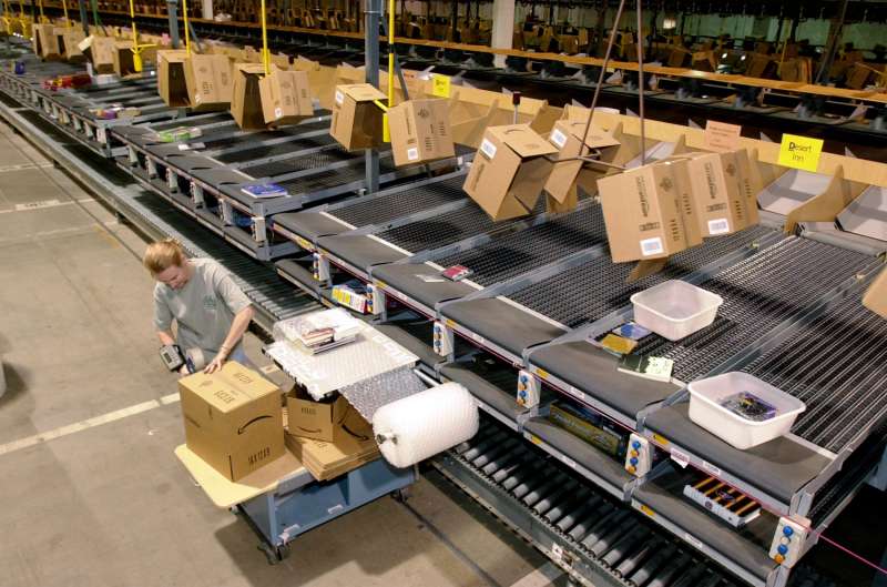 An Amazon employee packages an order to be shipped from its Coffeyville, Kan., warehouse.