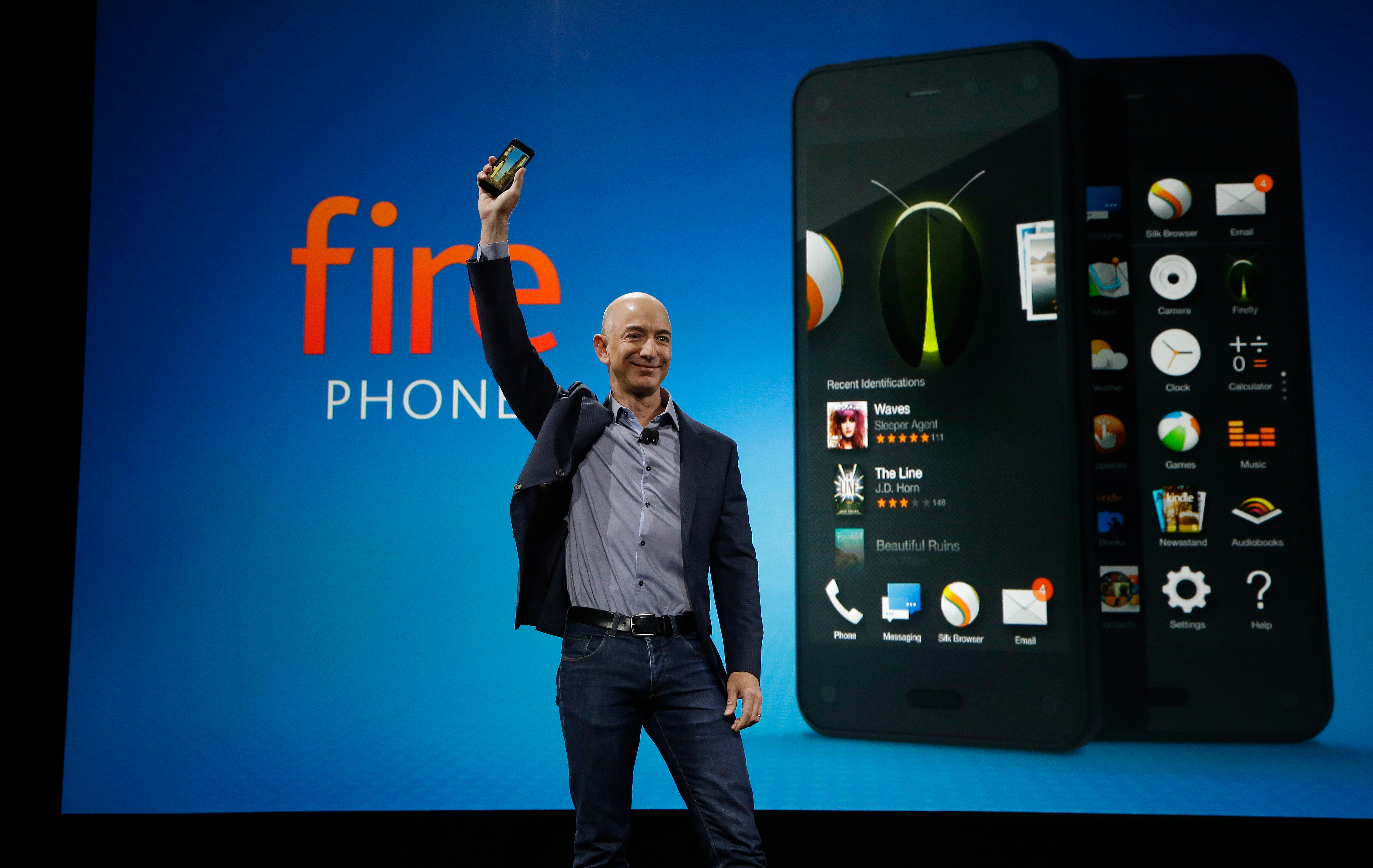 Amazon CEO Jeff Bezos holds up the new Amazon Fire Phone at a launch event, Wednesday, June 18, 2014, in Seattle.