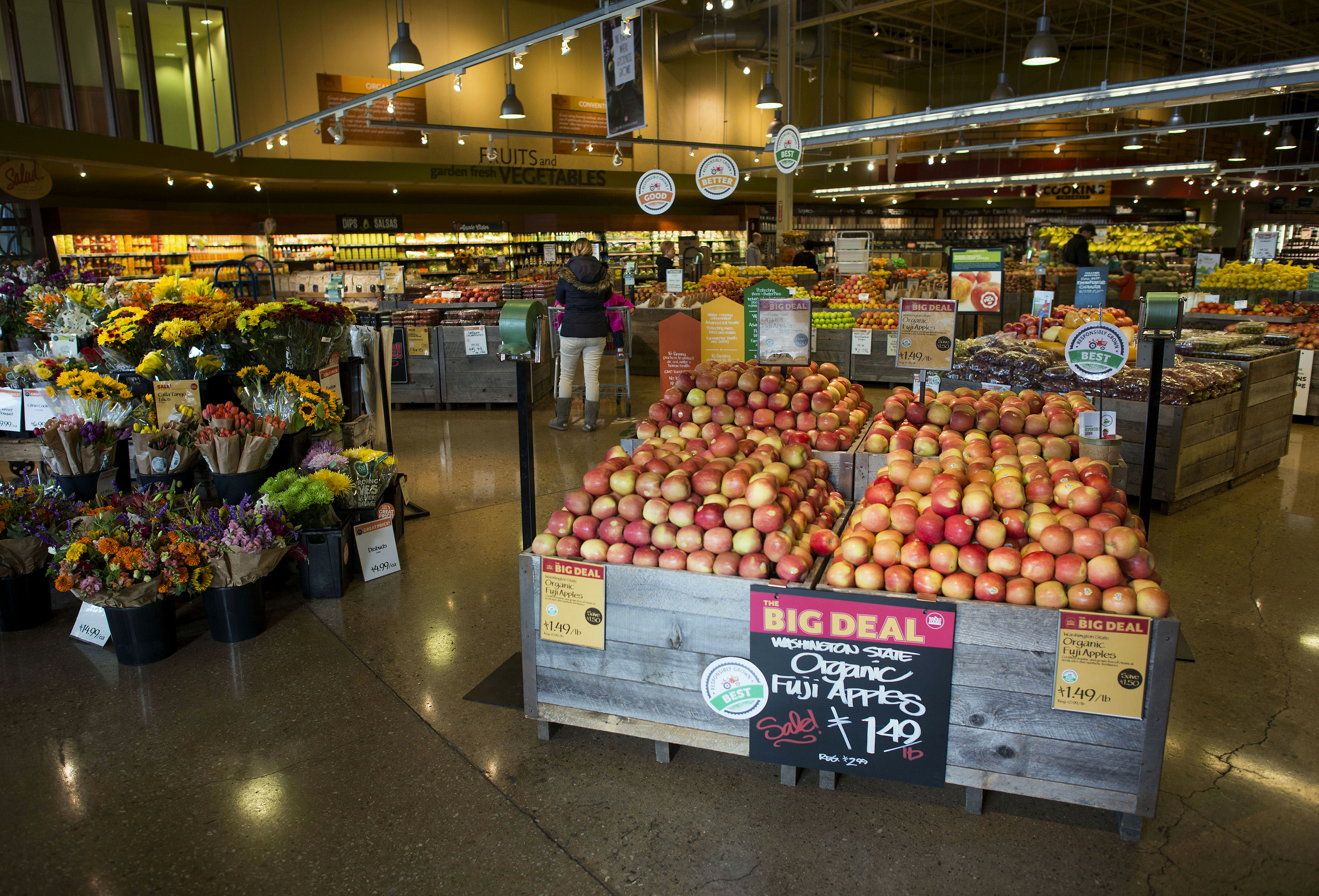 Customers shop in the produce section of a Whole Foods Market Inc. store in Dublin, Ohio, U.S., on Friday, Nov. 7, 2014.