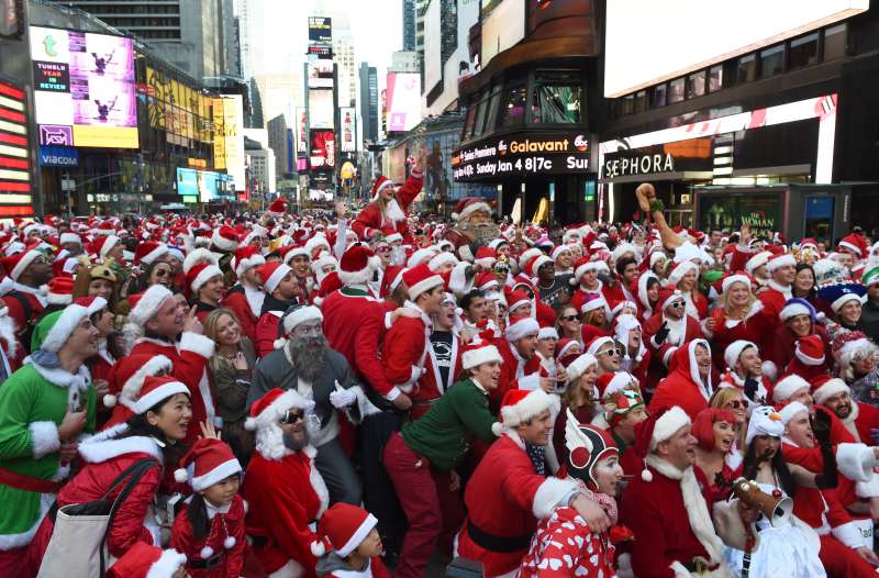 People dressed as Santa Claus and Mrs. Claus celebrate in Times Square as they gather for the annual Santacon festivities on Dec. 13, 2014 in New York.