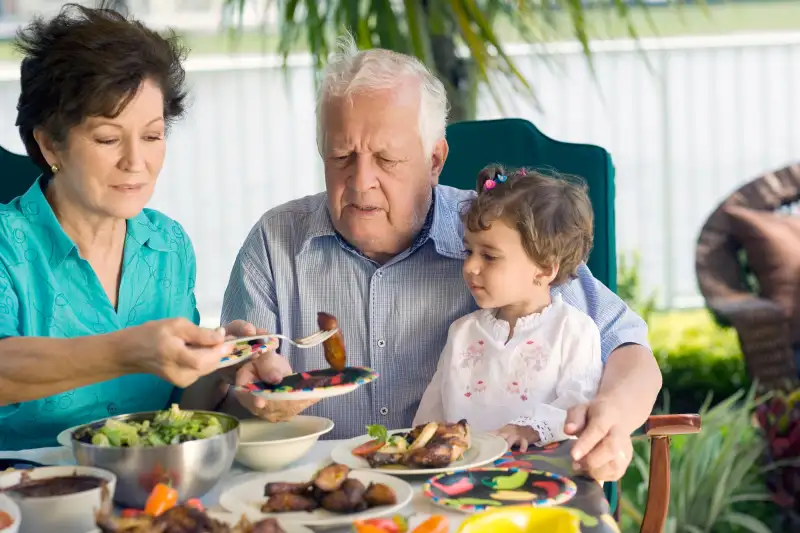 Grandfather at table of food