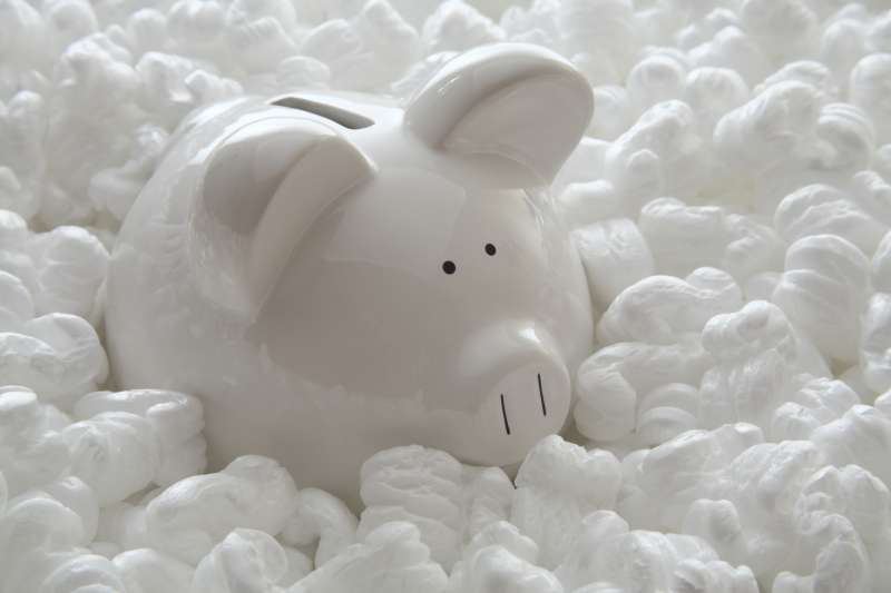 piggy bank surrounded by styrofoam peanuts
