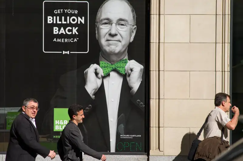 Pedestrians walk past an H&R Block, Inc. office in San Francisco, California.