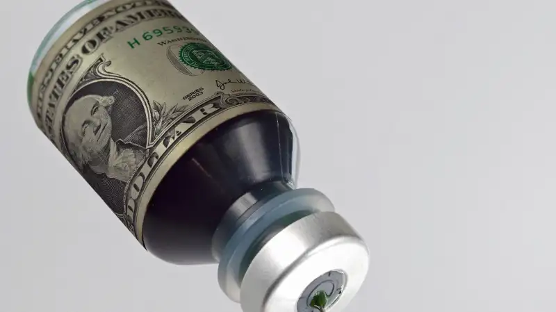 syringe taking liquid from money vial