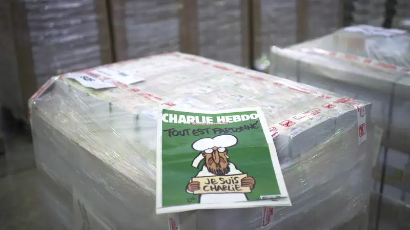 The weekly newspaper Charlie Hebdo, on January 13, 2015 in Villabe, south of Paris, a week after two jihadist gunmen stormed the Paris offices of the satirical magazine, killing 12 people including some of the country's best-known cartoonists. Its cover features the prophet with a tear in his eye, holding a Je Suis Charlie sign under the headline All is forgiven .