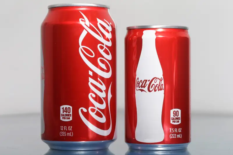 A 7.5-ounce can of Coca-cola, right, is posed next to a 12-ounce can for comparison.