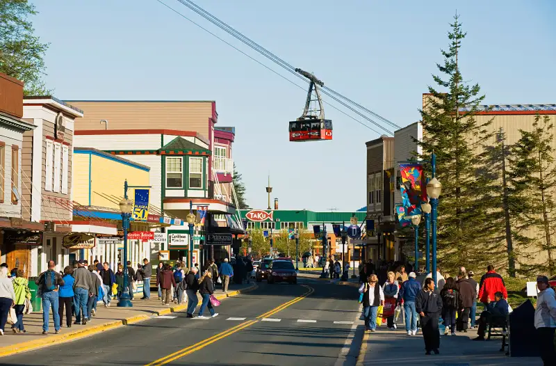 South Franklin Street with Mount Roberts tram car passing overhead in Downtown Juneau, Alaska.