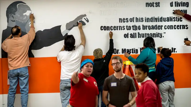 Volunteers paint walls and paint murals all over Coolidge High School during the Martin Luther King Day of Service organized by City Year in honoring the legacy of Dr. King in Washington DC on Monday, January 20, 2014.