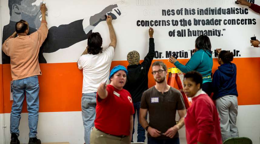 Volunteers paint walls and paint murals at Coolidge High School during the Martin Luther King Day of Service in Washington D.C. in 2014.