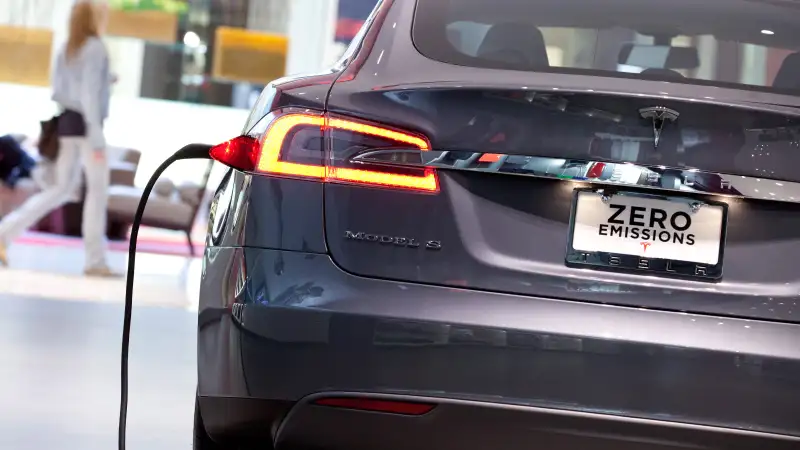 A Tesla Motors Inc. Model S connected to a charger at the Short Hills Mall in Short Hills, New Jersey