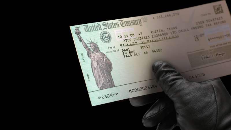 black glove holding US Treasury check