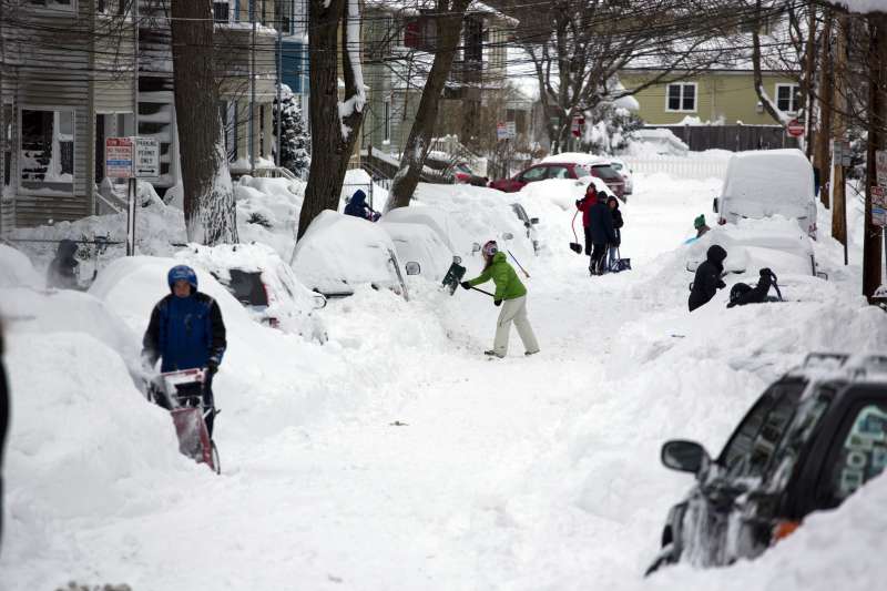On February 9, 2013, people dig out their cars in the Huron Village neighborhood in Cambridge, Massachusetts, USA, after winter storm Nemo hit the area. Winter storm Nemo dumped nearly 30 inches of snow on the region.