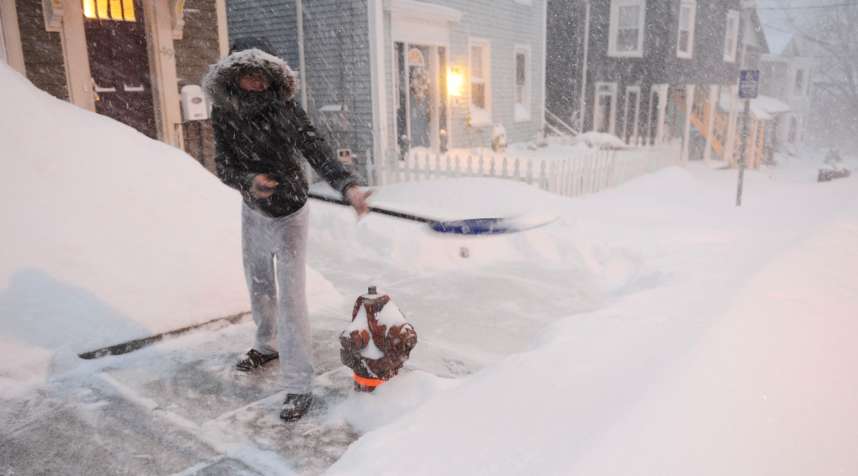 Shalonda Earvin clears the sidewalk in front of her Union St. home in Norwich, Conn., Tuesday, Jan.  27, 2015. Earvin said this was her fourth time out shoveling since it started snowing.