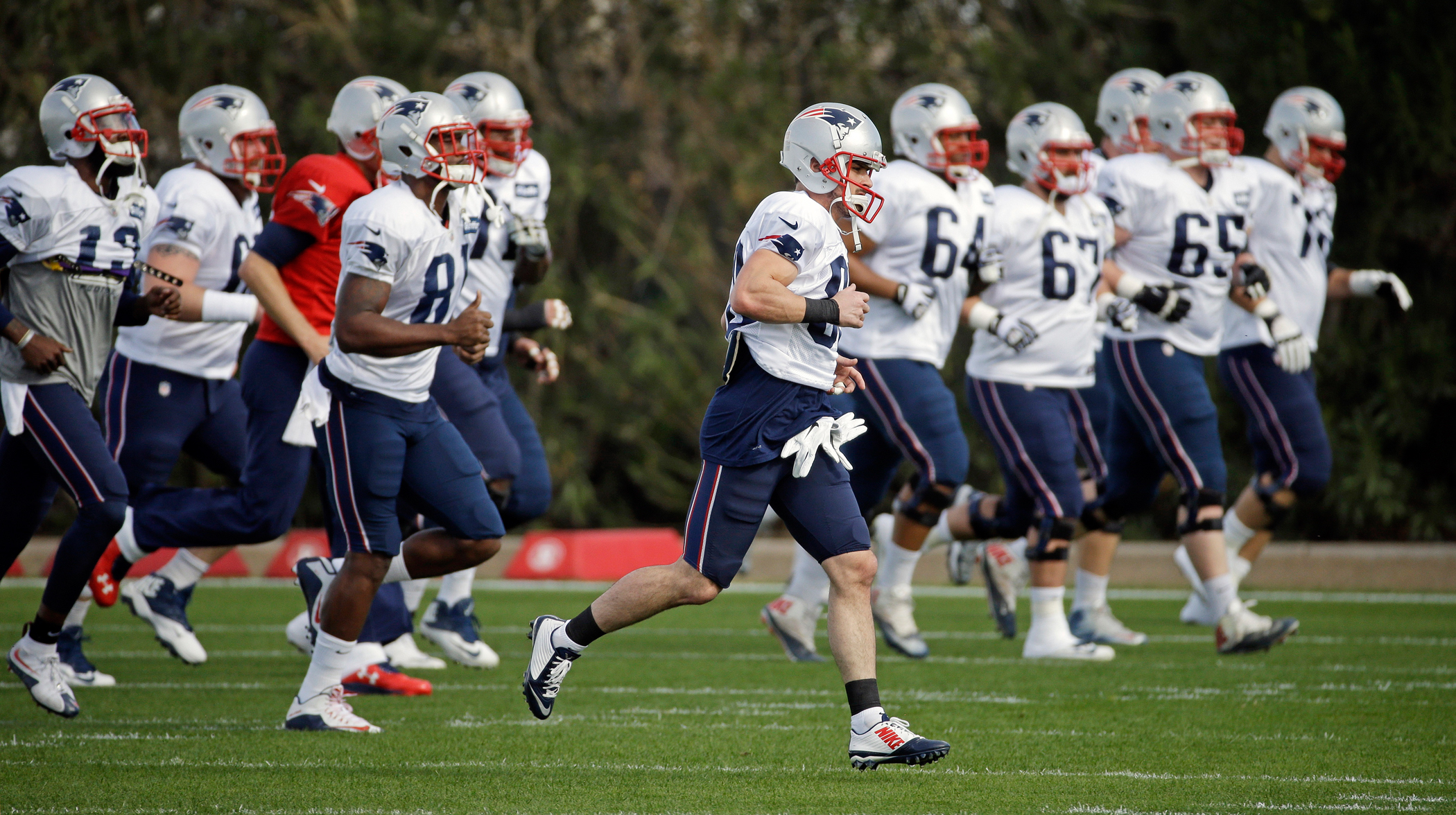 New England Patriots players warm up during practice Wednesday, Jan. 28, 2015, in Tempe, Ariz. The Patriots play the Seattle Seahawks in NFL football Super Bowl XLIX Sunday, Feb. 1, in Glendale, Ariz.150129_EM_SBNumbers_Payroll