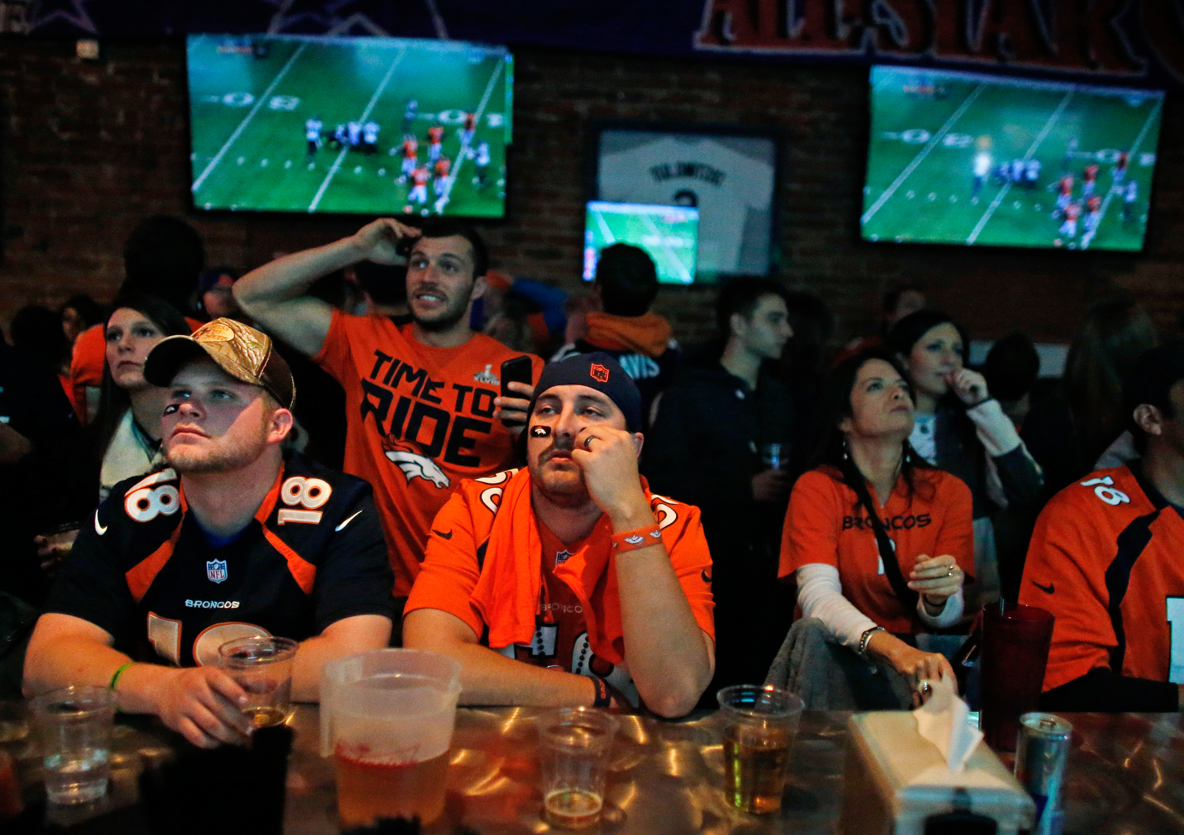 Denver Broncos fans watch their team play the Seahawks during the first half of the Super Bowl, inside Jackson's, a sports bar and grill in Denver.