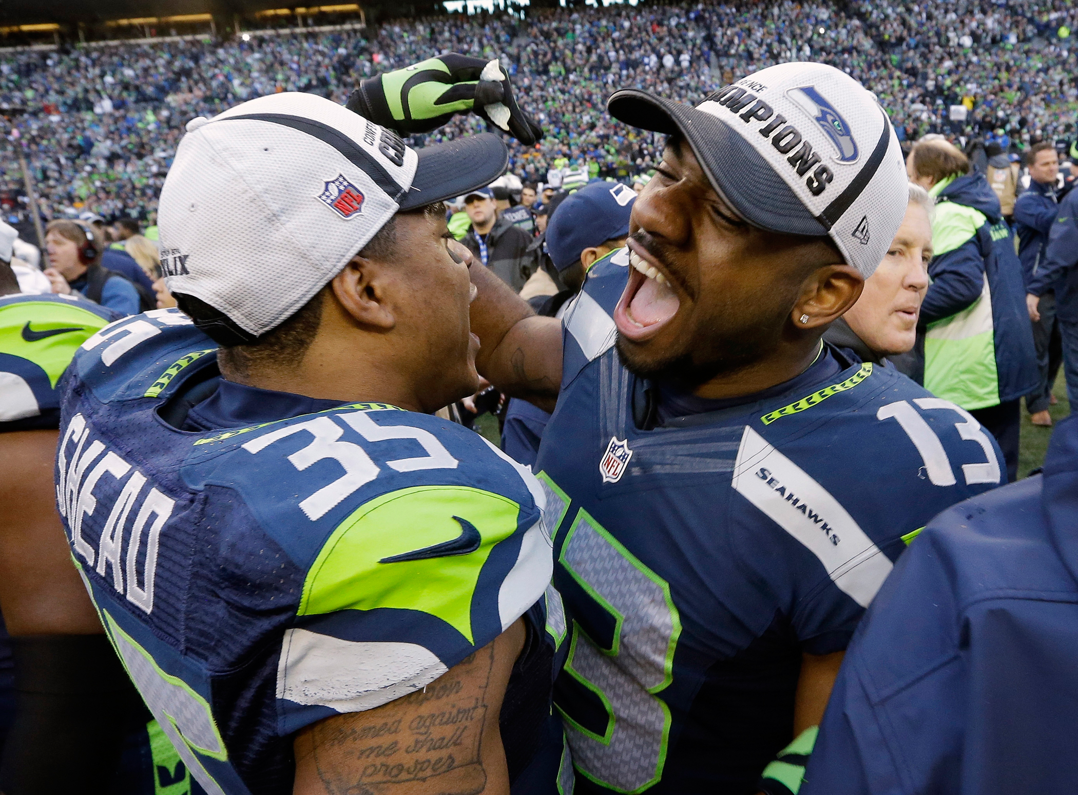 Seattle Seahawks' Chris Matthews (13) and DeShawn Shead celebrate after overtime of the NFL football NFC Championship game against the Green Bay Packers Sunday, Jan. 18, 2015, in Seattle.