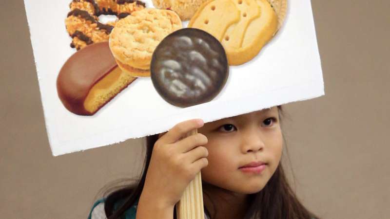Ashley Rubin, 9, holds a sign during Girl Scout Troop 582's cookie training session at Beach Vineyard Church in Panama City Beach, Florida, 2015.