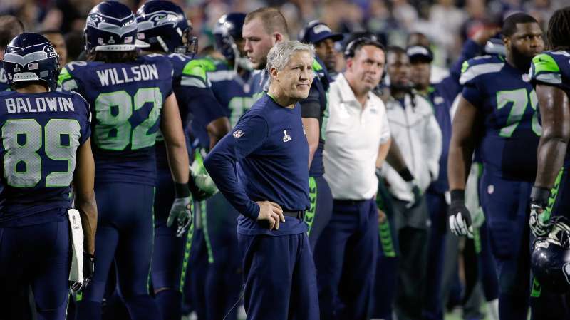 Seattle Seahawks head coach Pete Carroll, center, watches as players react after Russell Wilson was intercepted by New England Patriots strong safety Malcolm Butler during the second half of NFL Super Bowl XLIX football game Sunday, Feb. 1, 2015, in Glendale, Ariz.