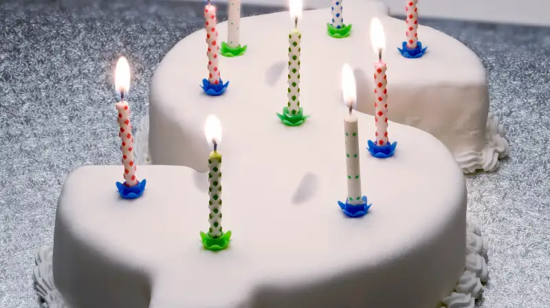 Dollar sign birthday cake with candles on top