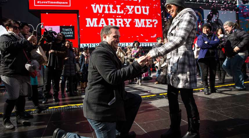 Tom Schwab, 37, proposes to his girlfriend of 18 months, Mary Nubla, 35, in Times Square on February 14, 2014 in New York City.  (She said yes.)