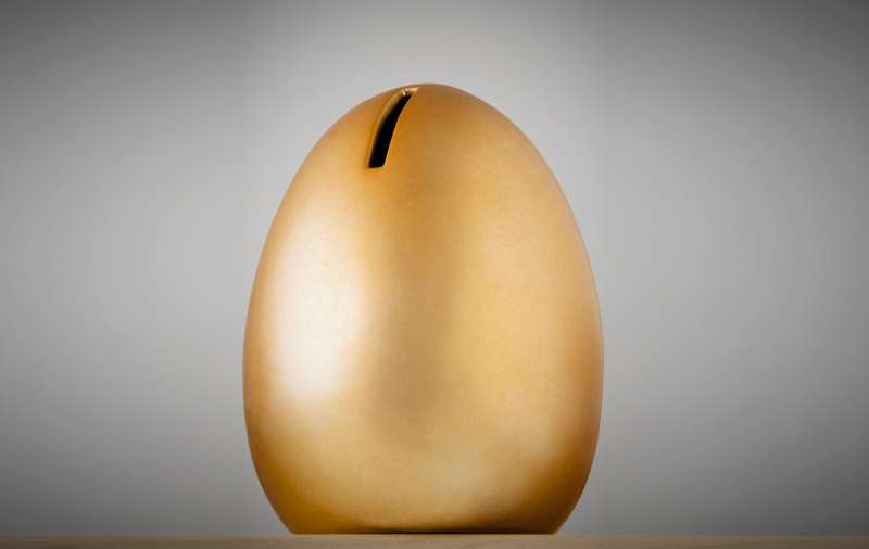 large golden egg with coin slot