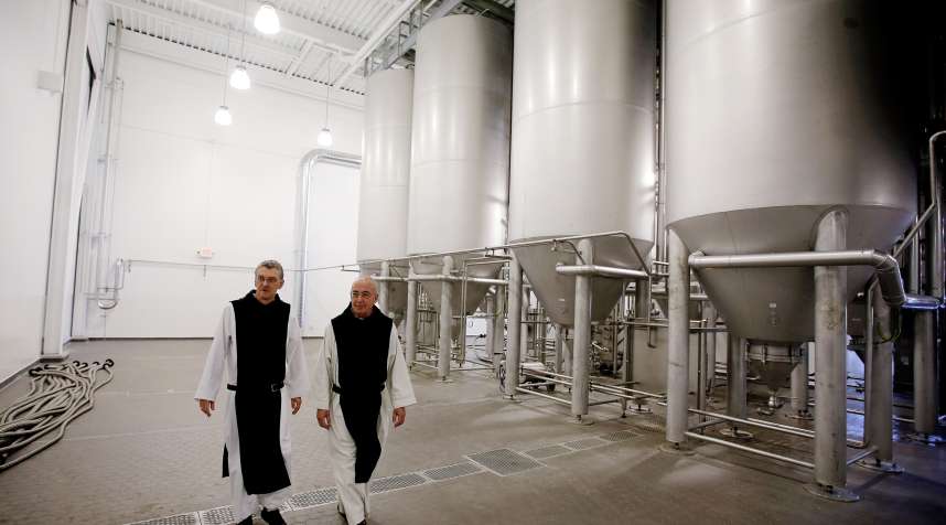Father Damion, abbot at St. Joseph's Trappist Abbey, left, and Spencer Brewery director Father Isaac, tour the monastery's brewery.