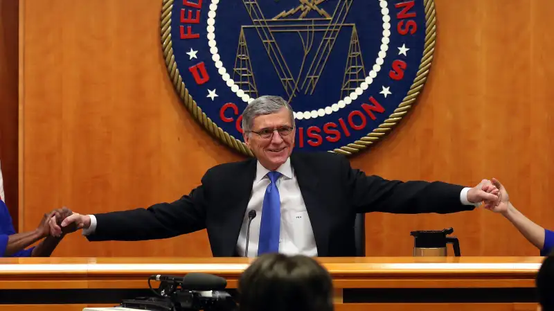 Federal Communications Commission Chairman Tom Wheeler (C) holds hands with FCC Commissioners Mignon Clyburn (L) and Jessica Rosenworcel during an open hearing on Net Neutrality at the FCC headquarters February 26, 2015 in Washington, DC. Today the FCC will vote on Net Neutrality seeking to approve regulating Internet service like a public utility, prohibiting companies from paying for faster lanes on the Internet.