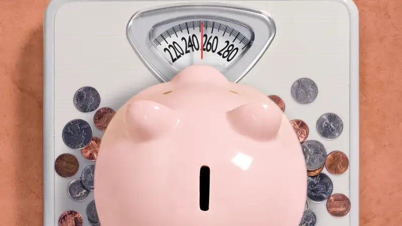 piggy bank stepping on scale