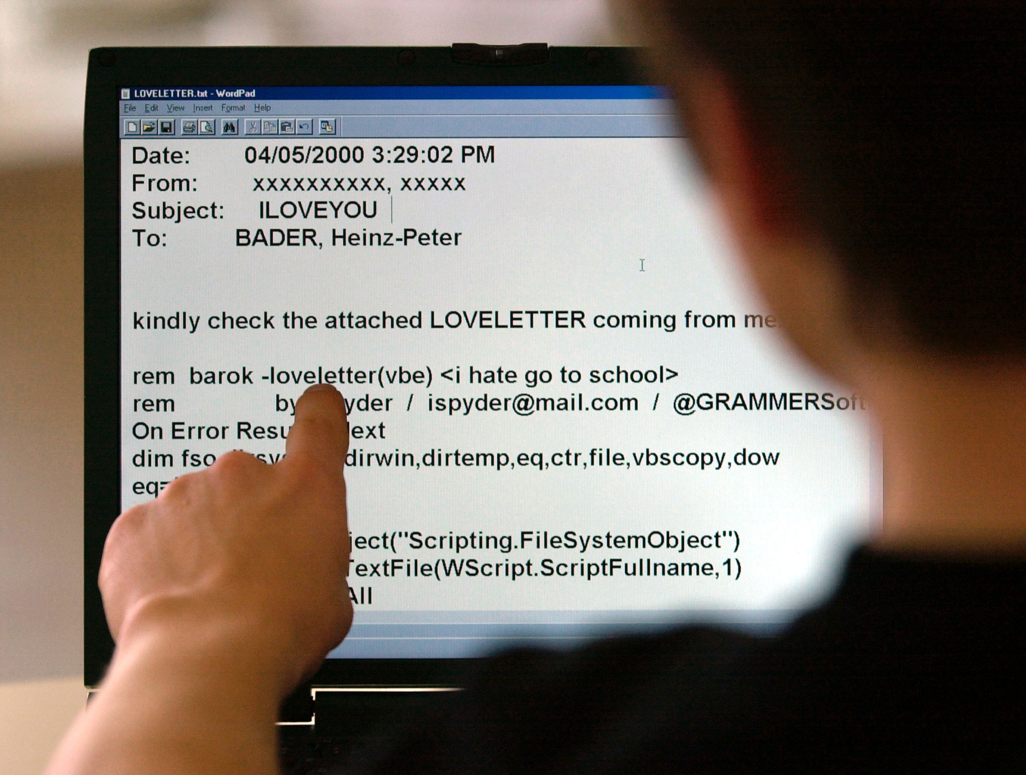 A computer user reads a program code attached to an e-mail dubbed the Love Bug May 5.
