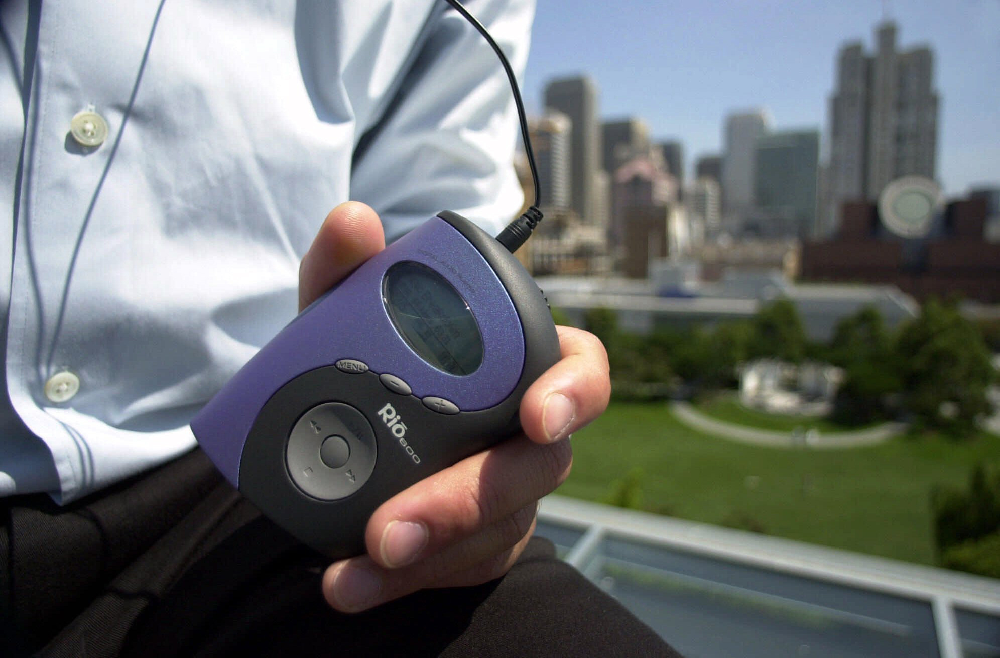 Ernesto Roy holds a Diamond Rio portable MP3 player in San Francisco on Thursday, July 27, 2000. The tiny device can store and play dozens of megabytes of downloaded MP3 music files. A federal court yesterday ordered an injuction against Napster, a major resource for MP3s on the internet.