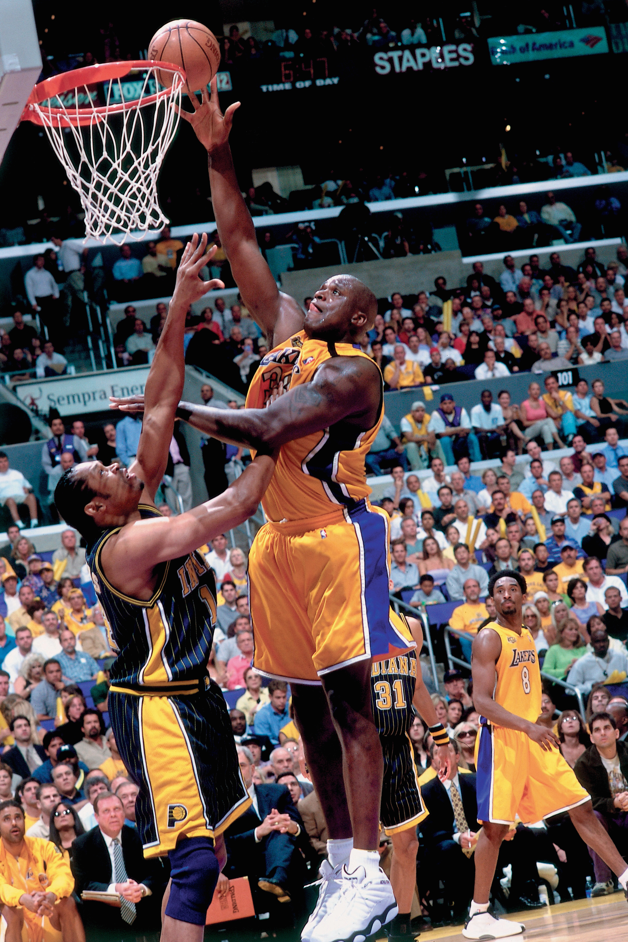 Shaquille O'Neal #34 of the Los Angeles Lakers attempts a layup against Sam Perkins #14 of the Indiana Pacers during Game 6 of the 2000 NBA Finals on June 19, 2000 at the Staples Center in Los Angeles, California.