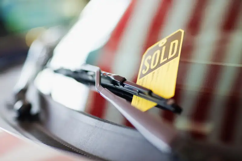 Car with sold sign on windshield
