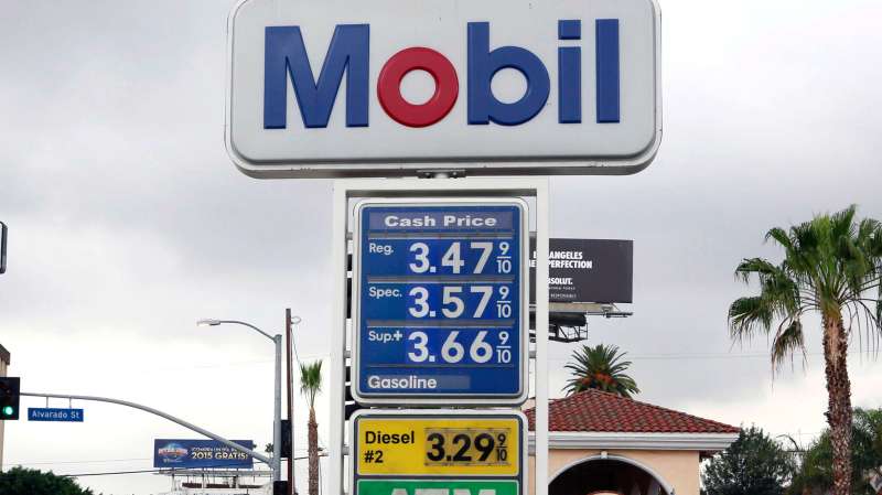 A cyclist rides by a sign at a gas station in Los Angeles posting the latest gas prices on Friday, Feb. 27, 2015. Gas prices in California soared overnight as a result of a combination of supply-and-demand factors worsened by the shutdown of two refineries that produce a combined 16 percent of the state’s gasoline.