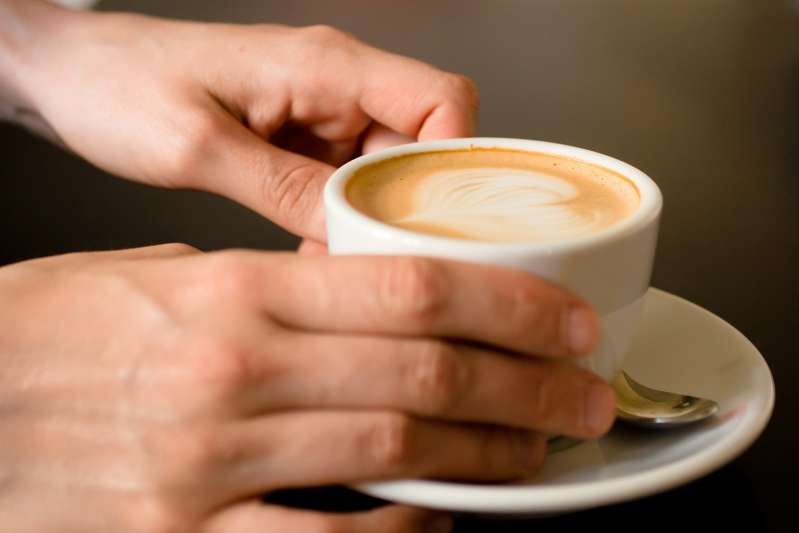 hands holding latte