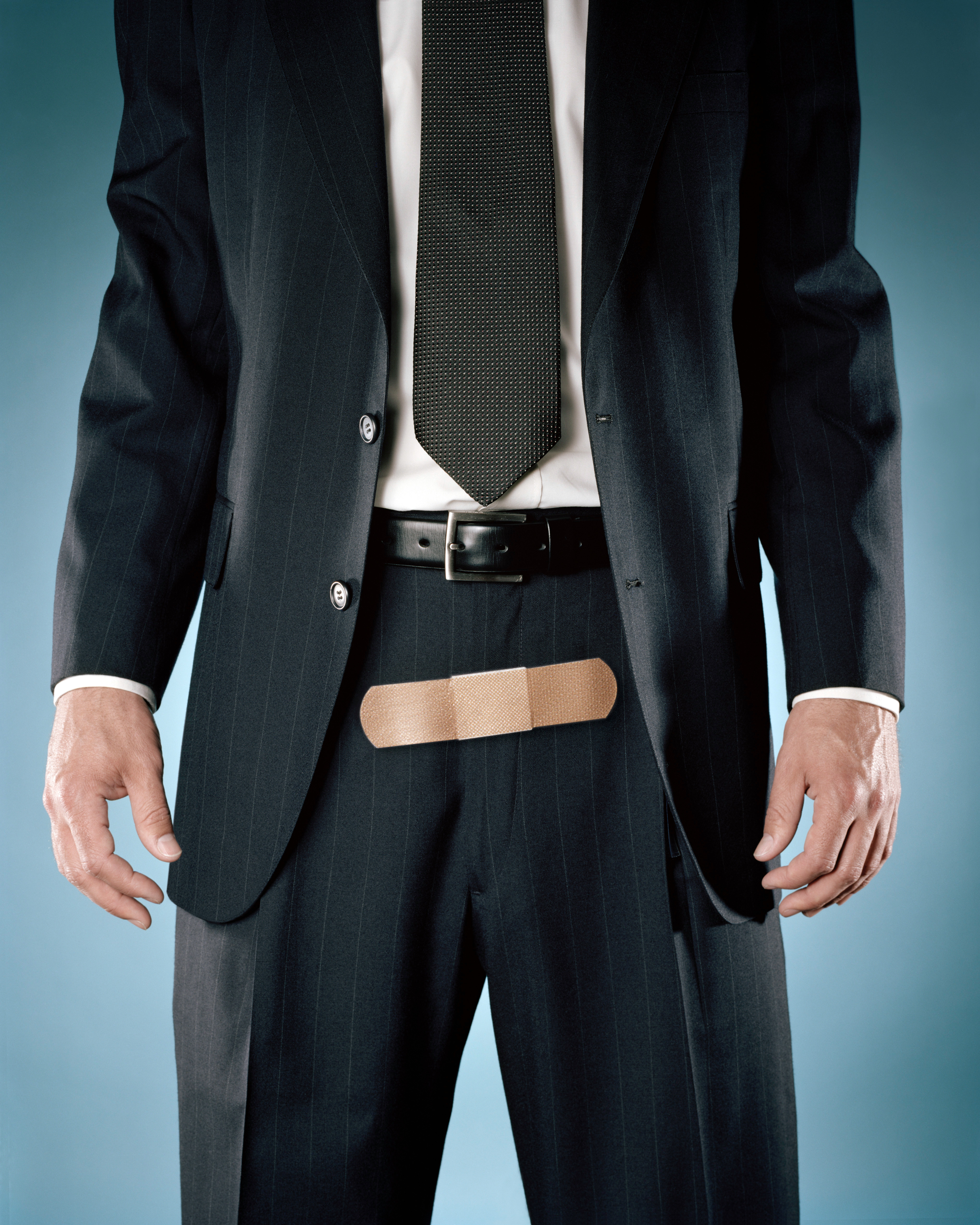 businessman with bandage on zipper