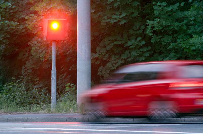 car speeding through red light