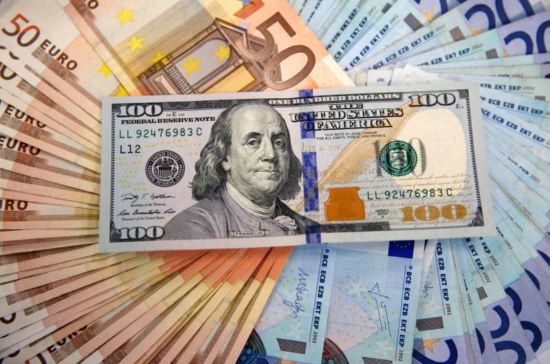 dollar sitting on fan of Euros