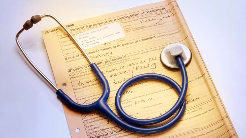 stethoscope on top of patient agreement for medical procedure form