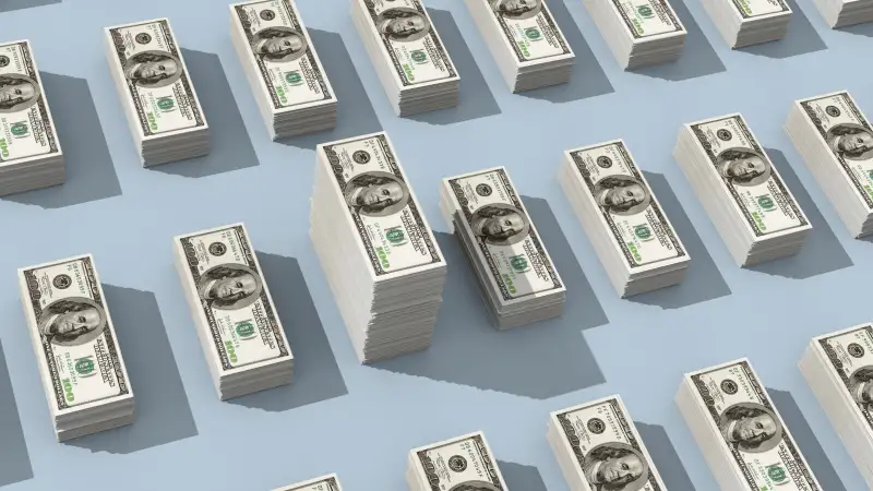 stacks of cash, one higher than the others