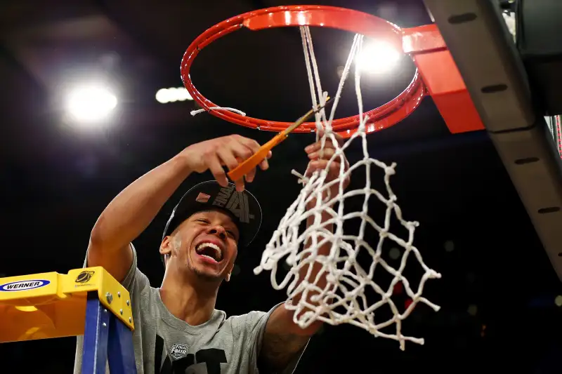 Shabazz Napier #13 of the Connecticut Huskies cuts down the net after defeating the Michigan State Spartans to win the East Regional Final of the 2014 NCAA Men's Basketball Tournament at Madison Square Garden on March 30, 2014 in New York City.