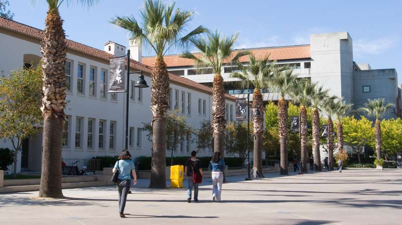 Students walking on El Paseo de Cesar Chavez street on San Jose State University campus, California