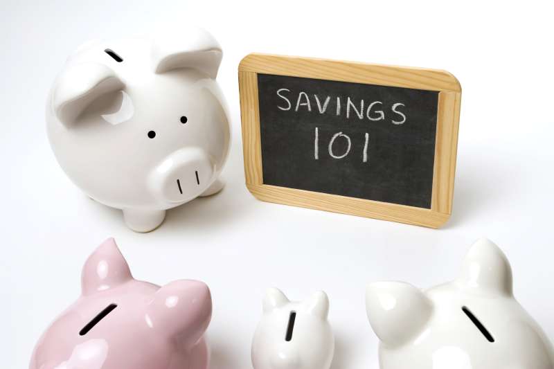 piggy banks with chalkboard saying  savings 101
