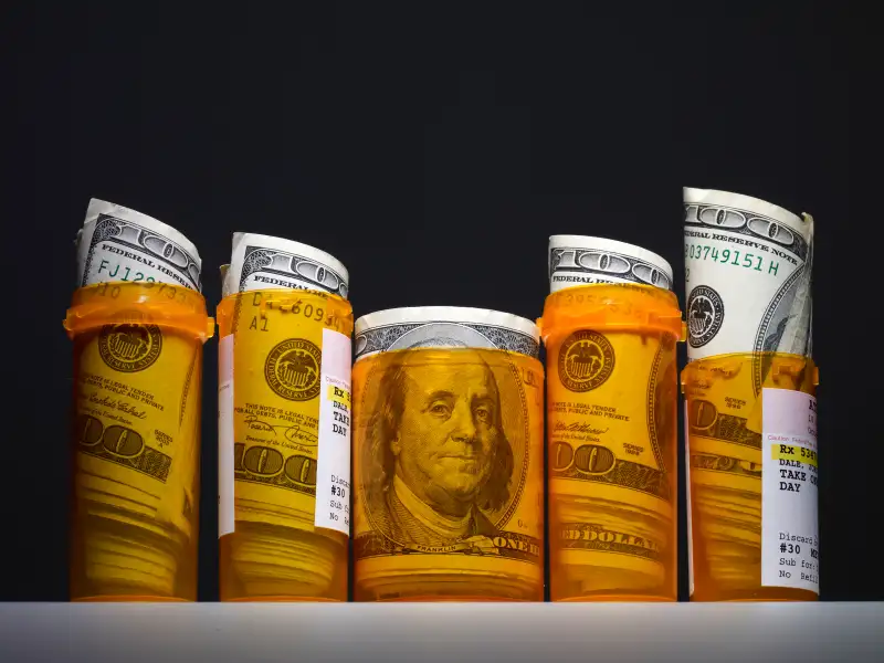 pill bottles with money in them