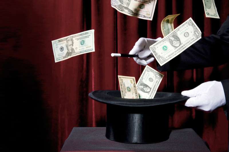 magician conjuring money from hat