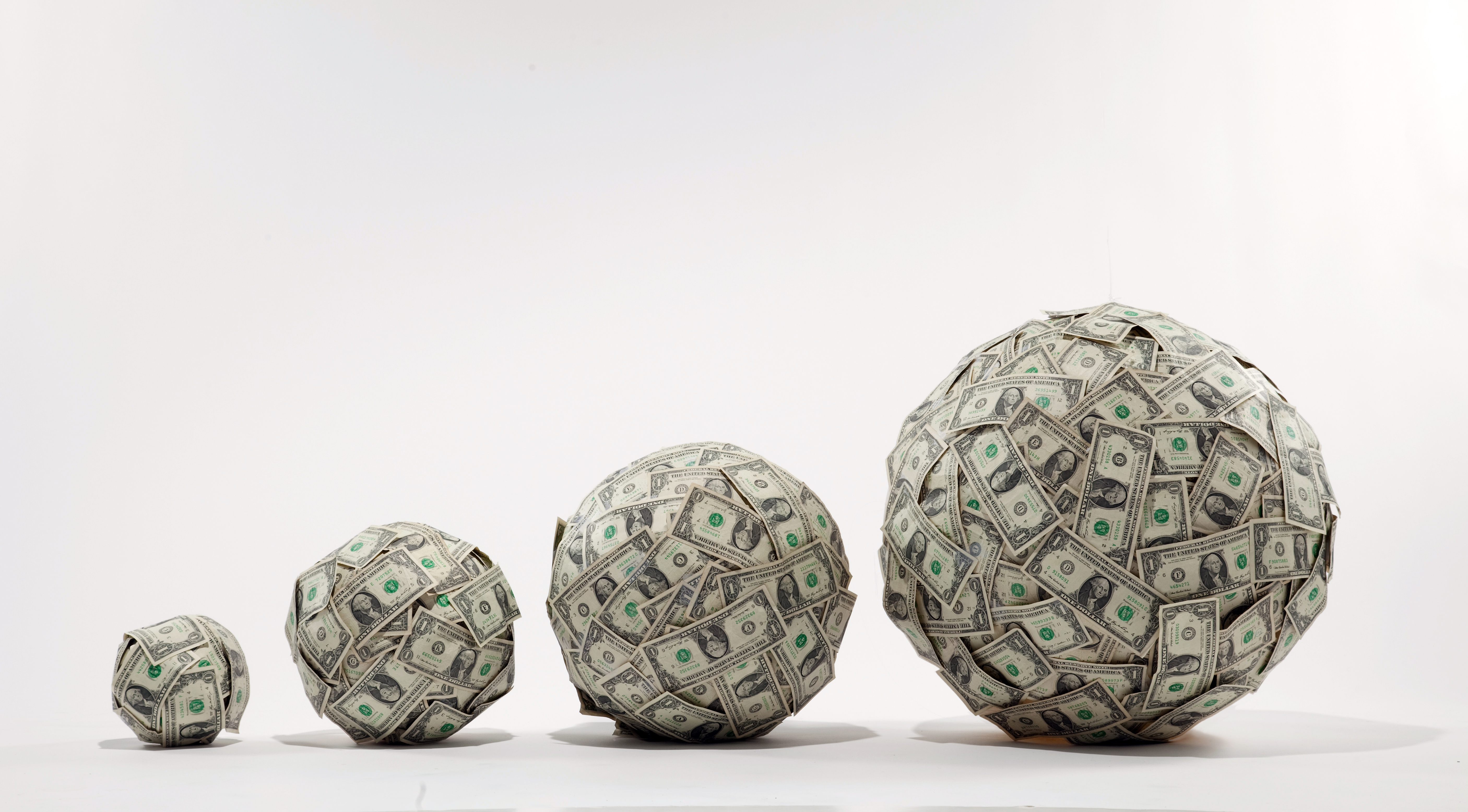 balls of cash increasing in size